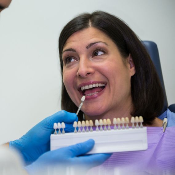 Dentist placing a dental crown on a patient’s tooth